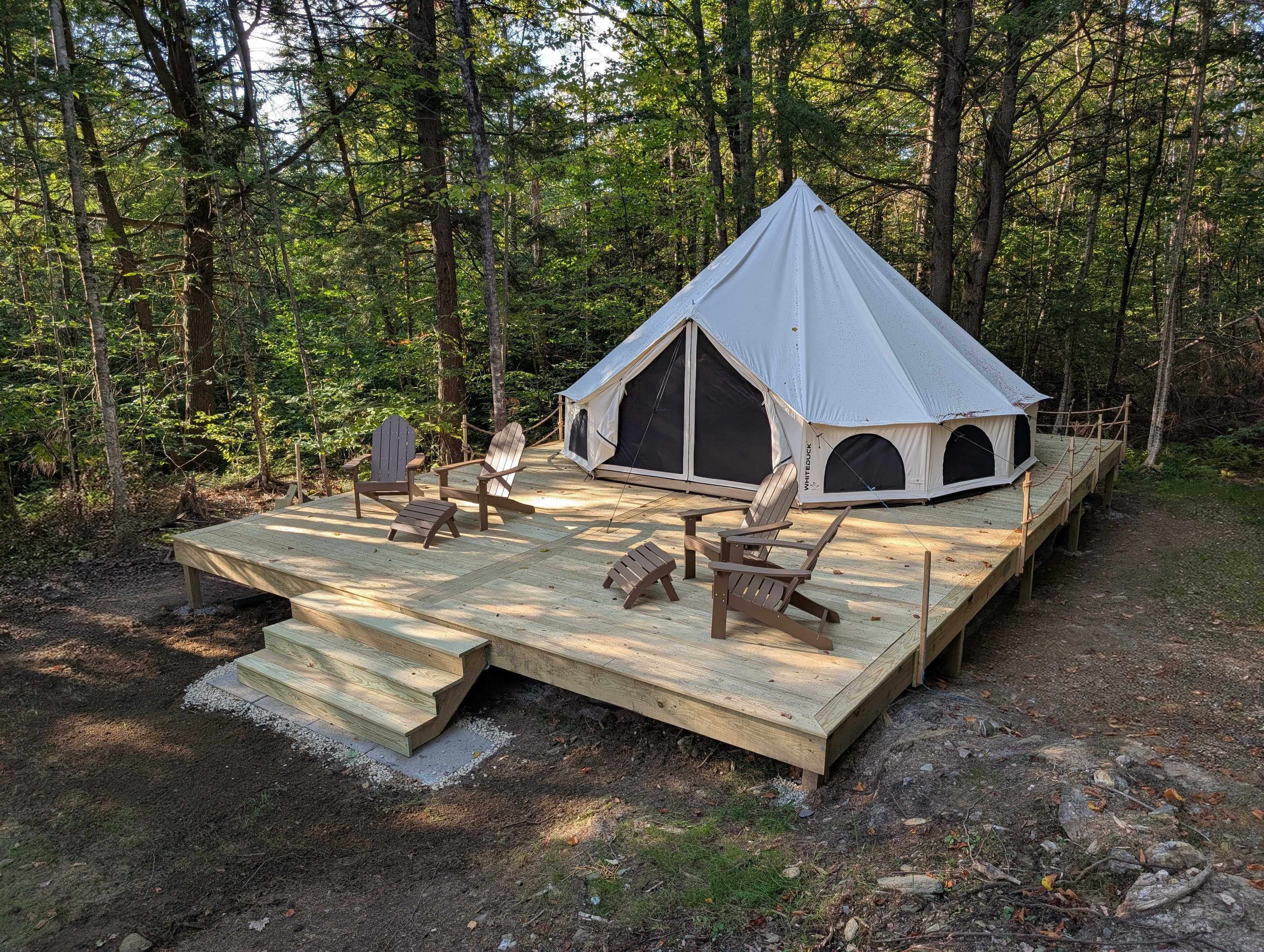 20' white bell tent on 22x32 platform with Adirondack chairs
